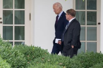 Former President Joe Biden speaks with White House Physician Kevin O'Connor as he arrives back at the White House in Washington, D.C., on Aug. 28, 2023.