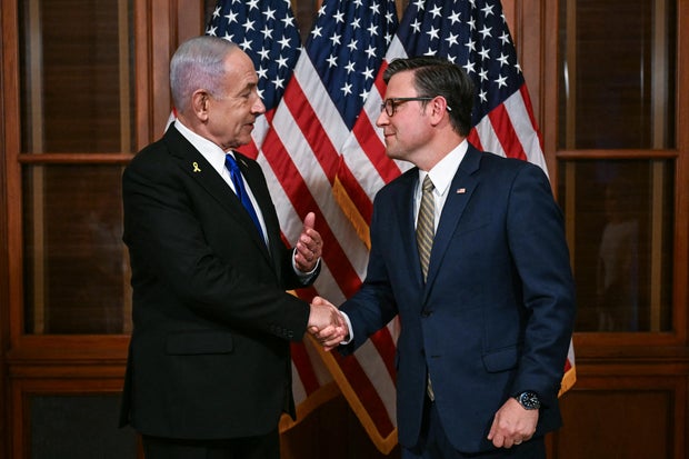 Speaker of the House Mike Johnson shakes hands with Israeli Prime Minister Benjamin Netanyahu as they meet at the US Capitol in Washington, DC, on July 8, 2025.